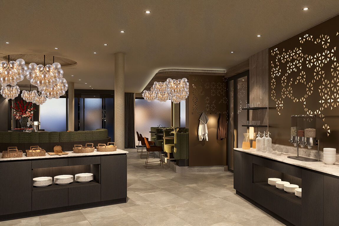 Moderner Buffetbereich mit Theken aus dunklem Holz, ordentlich angeordnetem Geschirr, Getränkespendern und dekorativer Beleuchtung. Gold- und Brauntöne dominieren den Raum, mit gemusterten Wandpaneelen und stilvollen Hängelampen.